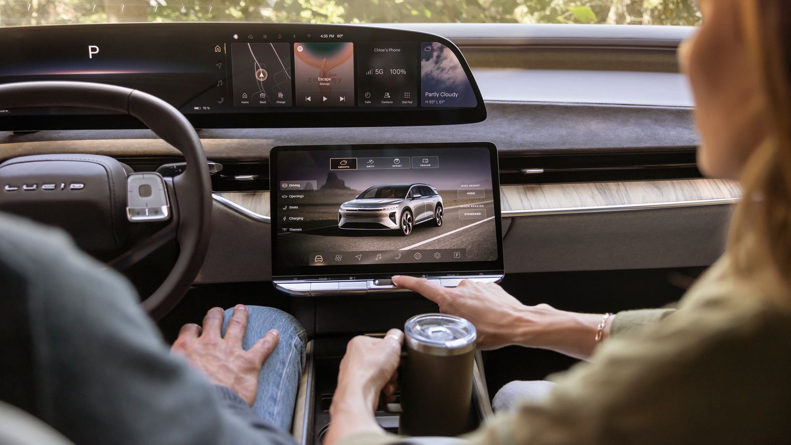 Image may contain Adult Person Car Transportation Vehicle Cup Computer Electronics Laptop Pc Head and Accessories
